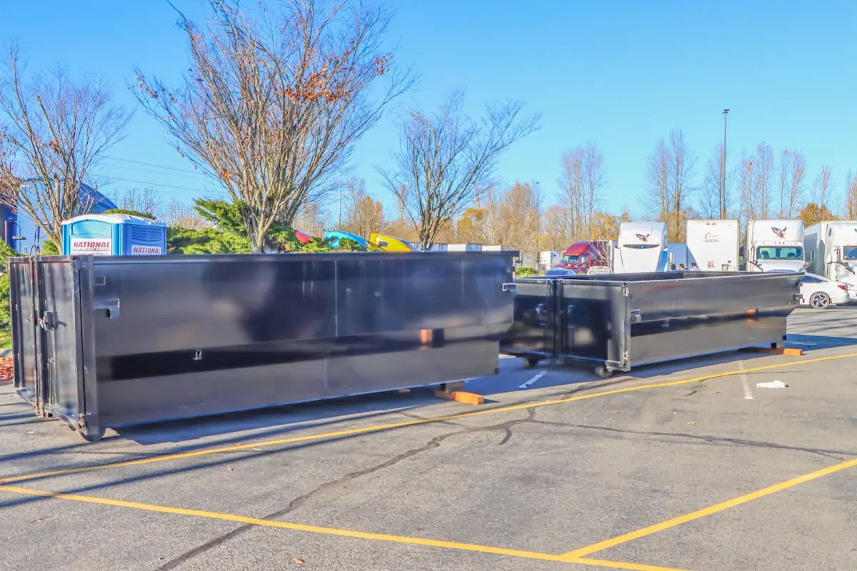 Professional dumpster rental service with roll-off container on residential driveway in Bartonville